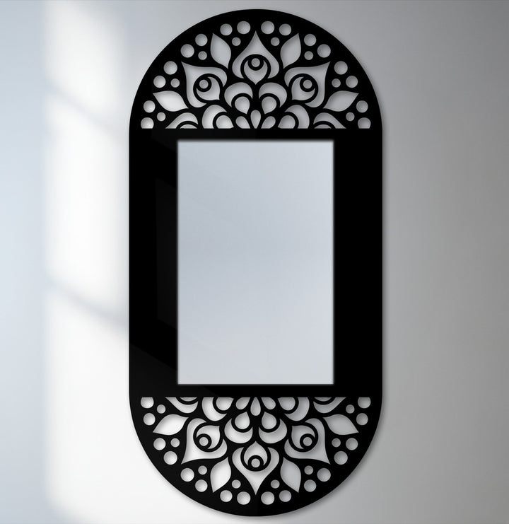 Darkest area highlighting the mandala floral pattern on the black metal frame of this decorative oval mirror for wall decor, creating an elegant and artistic focal point.