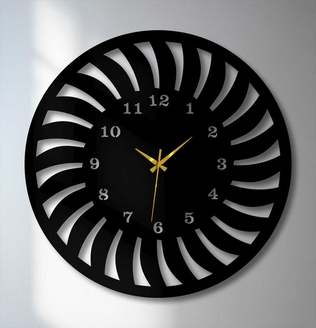 The unmoving, striking gold hands of this radial pattern metal artwork clock convey serene stillness against its modern black spiral design.