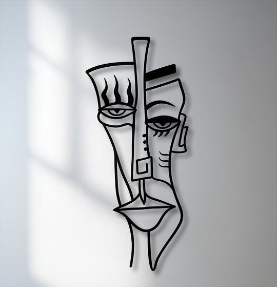 Capturing the abstract quality, this unique metal wall art depicts a cubist tribal face with bold lines and striking shadow play.
