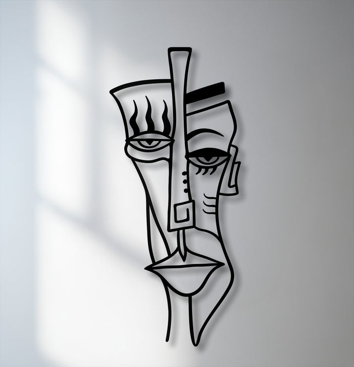 Capturing the abstract quality, this unique metal wall art depicts a cubist tribal face with bold lines and striking shadow play.
