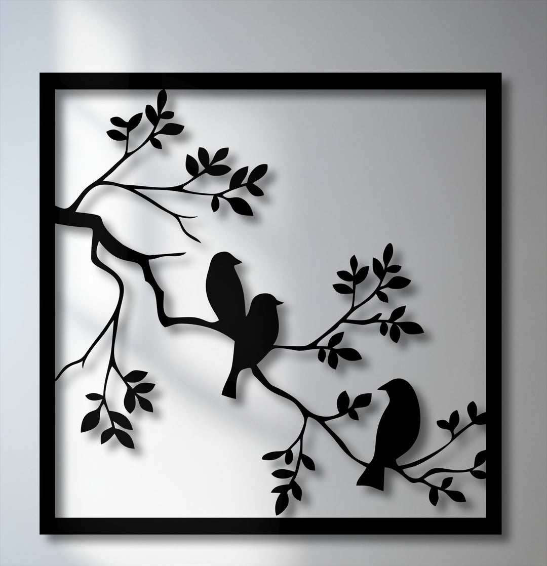 A cool color temperature enhances this striking metal artwork, showcasing three minimalist birds perched on branches within a sleek frame.