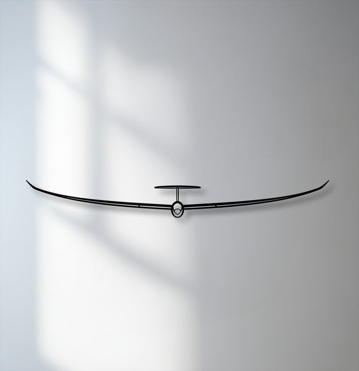 The stark black silhouette of the minimalist glider metal art for wall offers a striking color contrast against the subtle grey-white backdrop.