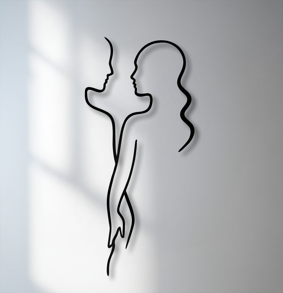 Soft shadows embrace the minimal couple line metal wall decor, highlighting its modern love silhouette against a luminous background.
