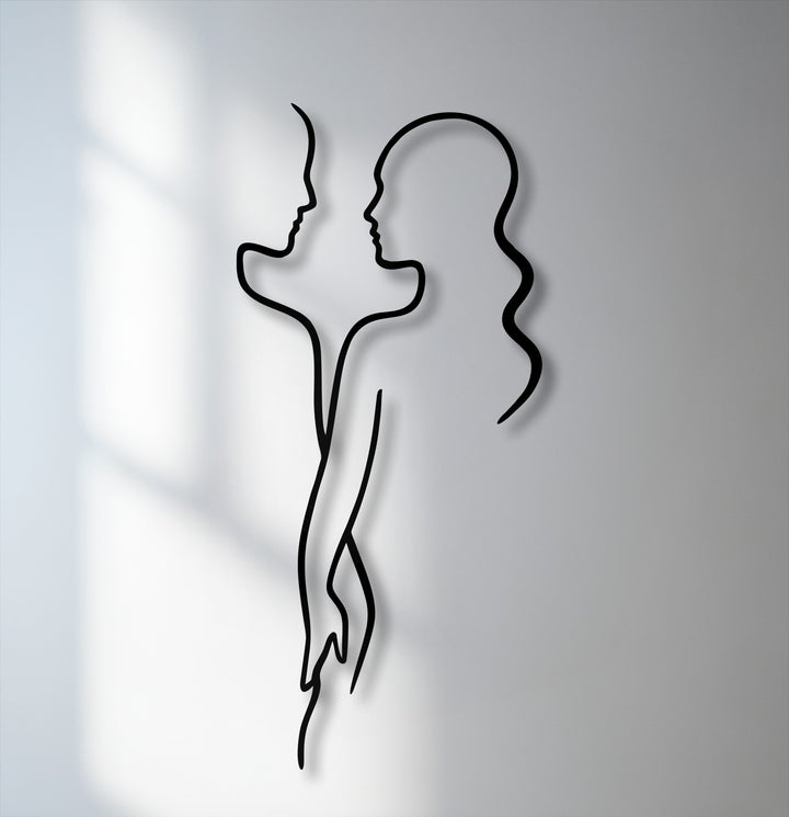 Soft shadows embrace the minimal couple line metal wall decor, highlighting its modern love silhouette against a luminous background.