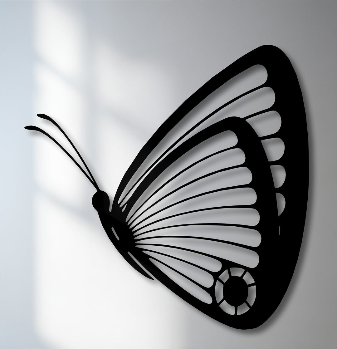 The negative space beautifully outlines this black butterfly decorative metal art, showcasing its graceful, intricately detailed wings.