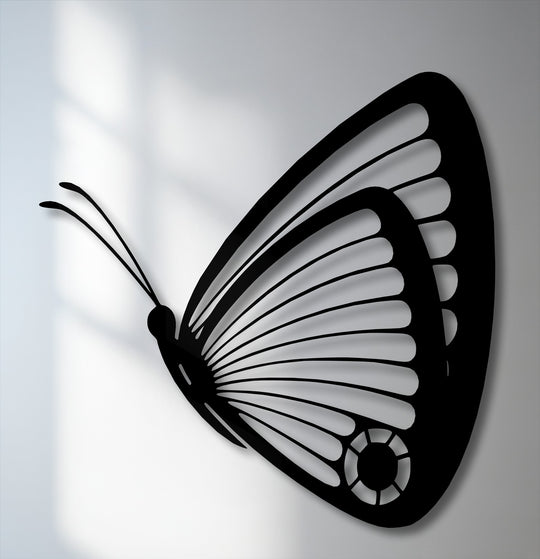 The negative space beautifully outlines this black butterfly decorative metal art, showcasing its graceful, intricately detailed wings.