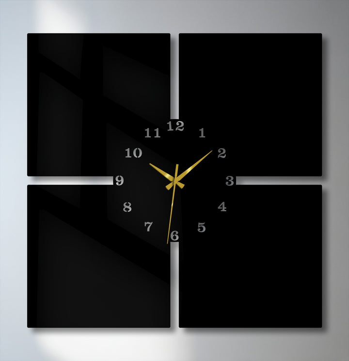 Crisp edges and panel borders define this modern 4-piece metal wall clock, a sleek black decoration wall art with gold hands.