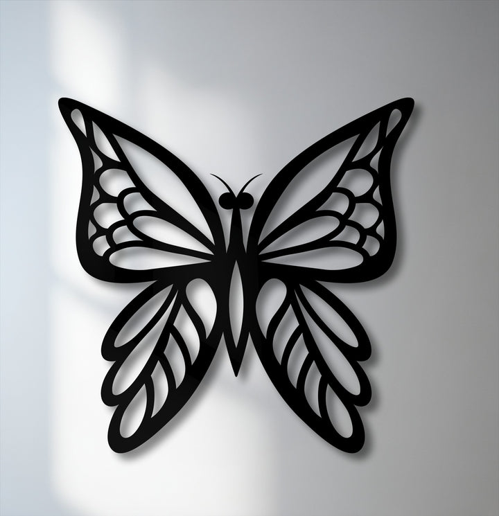The elegant butterfly metal artwork, with its delicate, open wings, appears poised for flight, creating a dynamic sense of upward movement and lightness.