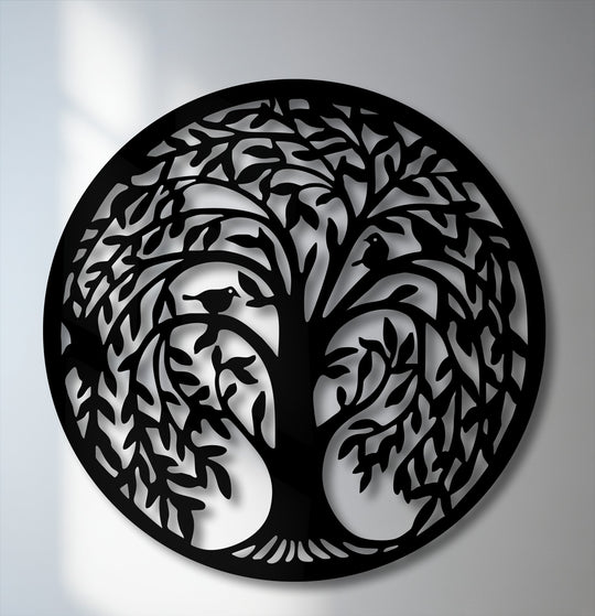 The cool color temperature highlights the intricate black Tree of Life circular silhouette, a unique metal wall art piece with birds perched in its branches.