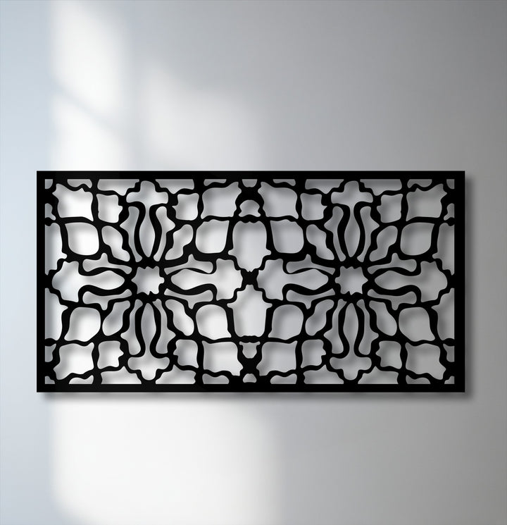 The bold, intricate black ornamental geometric pattern of this metal decoration wall art panel casts dramatic shadows.