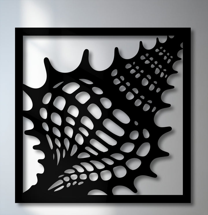 Focusing on the darkest area, an intricate black Ocean Texture seashell frame metal wall decor features organic perforations and sharp contrasts.