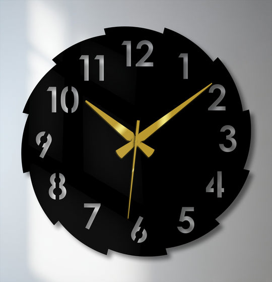 Striking gold clock hands loudly announce the time against a black segmented dial in this unique metal wall art clock with prominent numerals.