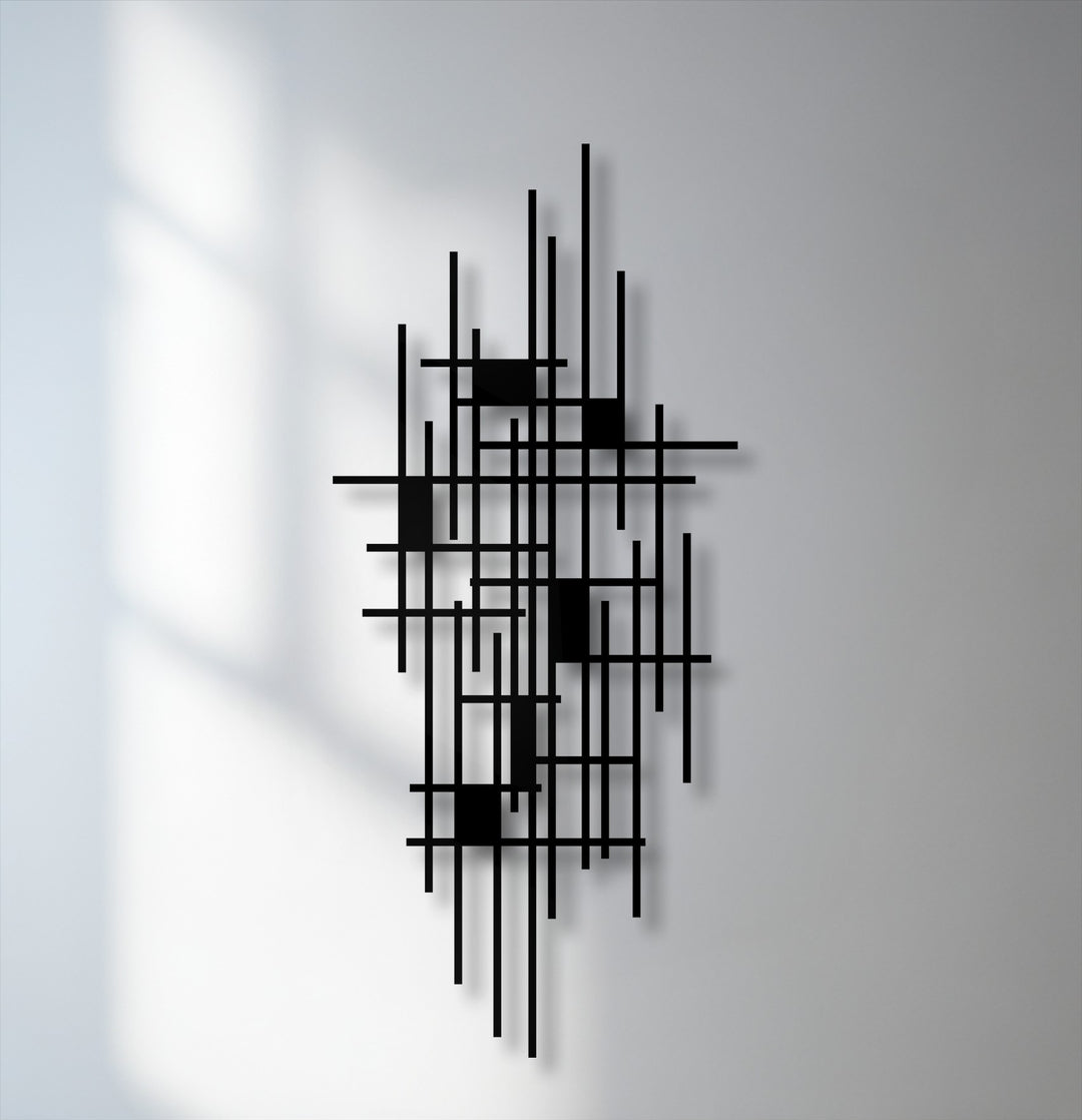The brightest area reveals soft window shadows falling across the wall next to the striking black unique metal wall art.