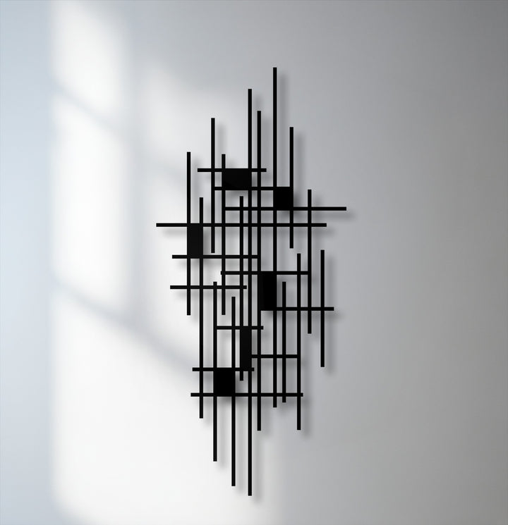 The brightest area reveals soft window shadows falling across the wall next to the striking black unique metal wall art.