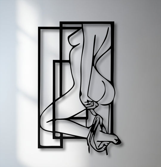 The unique metal wall art features a layered abstract feminine silhouette, creating visual depth with its geometric frames and cast shadows.