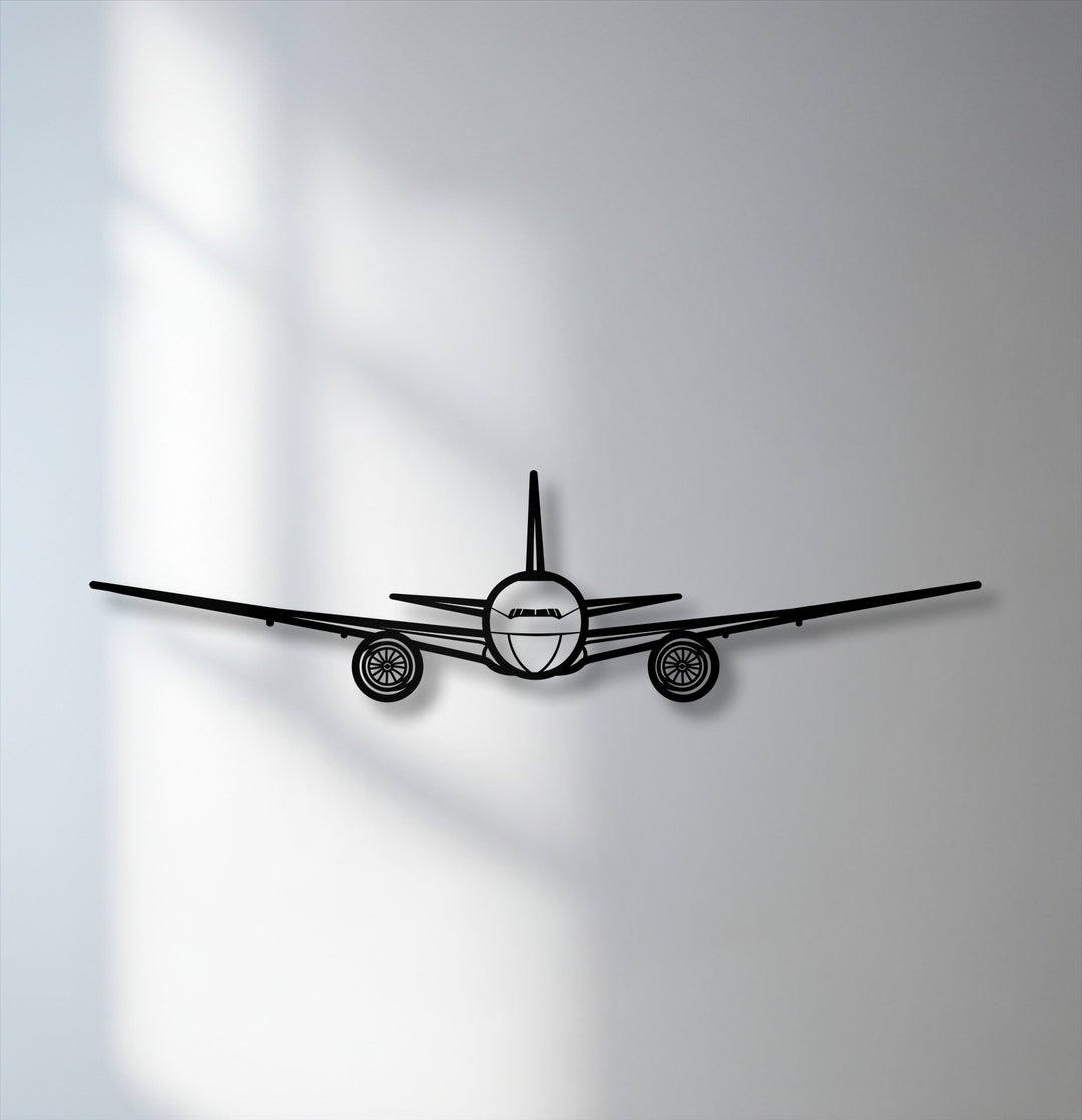 A bold front view airplane silhouette, as striking aviation metal art for wall, stands out against a softly shadowed background.