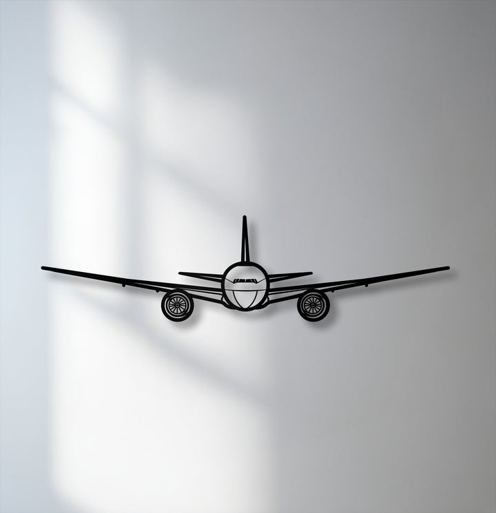 A bold front view airplane silhouette, as striking aviation metal art for wall, stands out against a softly shadowed background.