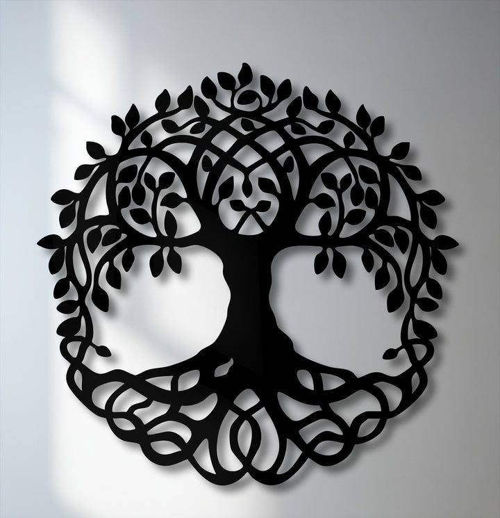 The softest element, delicate shadows, gently outlines the intricate Celtic Tree of Life metal wall decor, adding depth to the artwork.