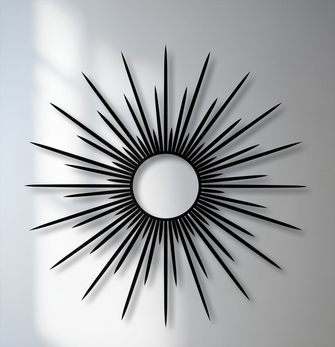 Evoking a bold and sophisticated mood, this radiant black sunburst metal wall decor features striking, elongated rays.