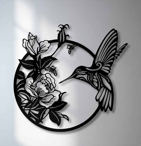 The smooth, matte black surface texture of this unique metal wall art elegantly showcases a graceful hummingbird and blooming flowers.