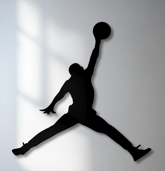 The organic forms of a leaping basketball player silhouette create dynamic metal decoration wall art, perfect for sports action decor.