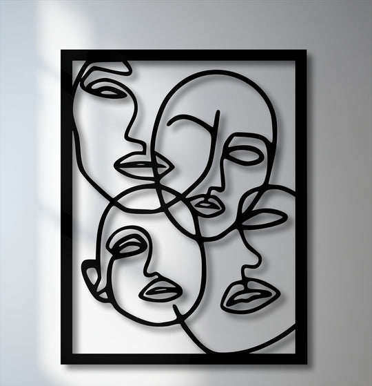 The matte black finish of this dimensional Abstract Faces Line Art metal wall decor creates striking shadows, enhancing its minimalist portrait design.