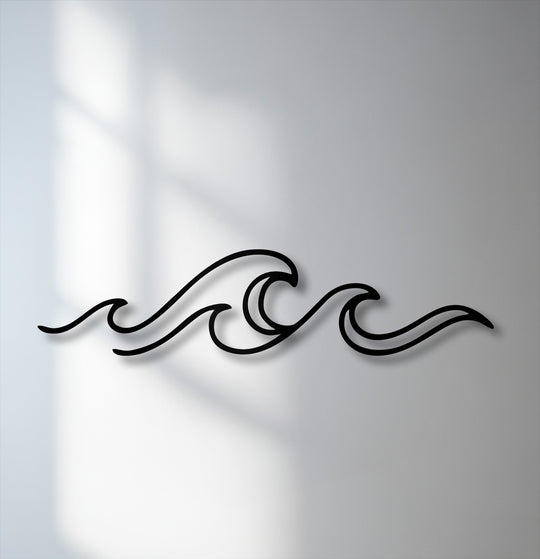 Gentle, diffused shadows softly blend with the minimalist ocean wave line decorative metal art, creating a serene ambiance on the wall.