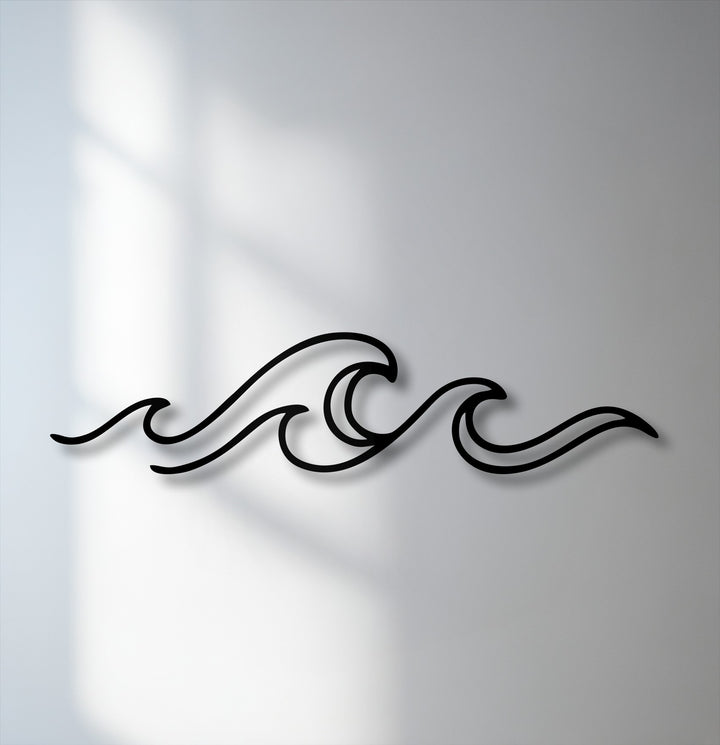 Gentle, diffused shadows softly blend with the minimalist ocean wave line decorative metal art, creating a serene ambiance on the wall.