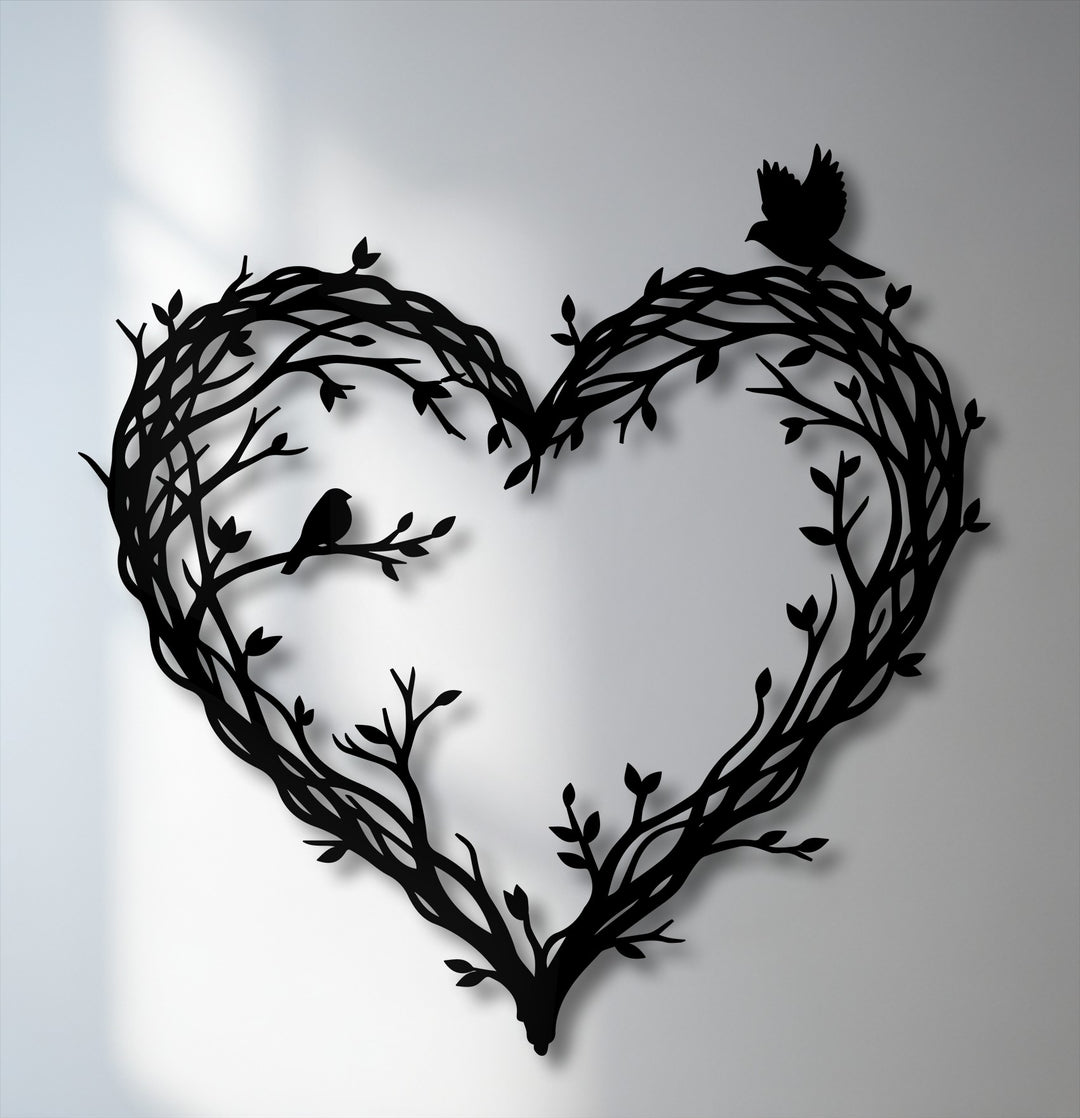 Soft, diffused shadows gently highlight the elegant metal wall decor, featuring intertwined branches forming a heart with two delicate birds.