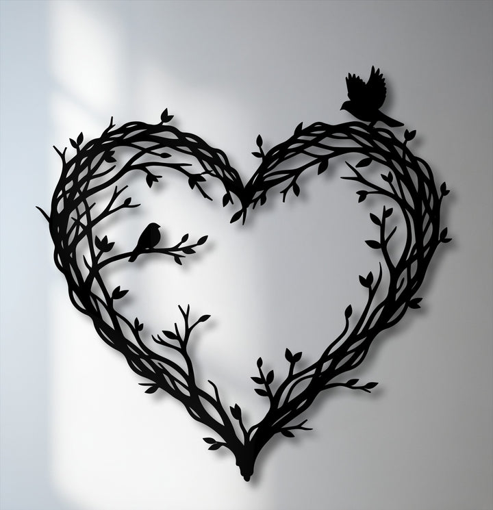 Soft, diffused shadows gently highlight the elegant metal wall decor, featuring intertwined branches forming a heart with two delicate birds.