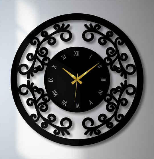 The color shift from black numerals to gold hands highlights the ornamental floral frame on this vintage metal wall decor clock.