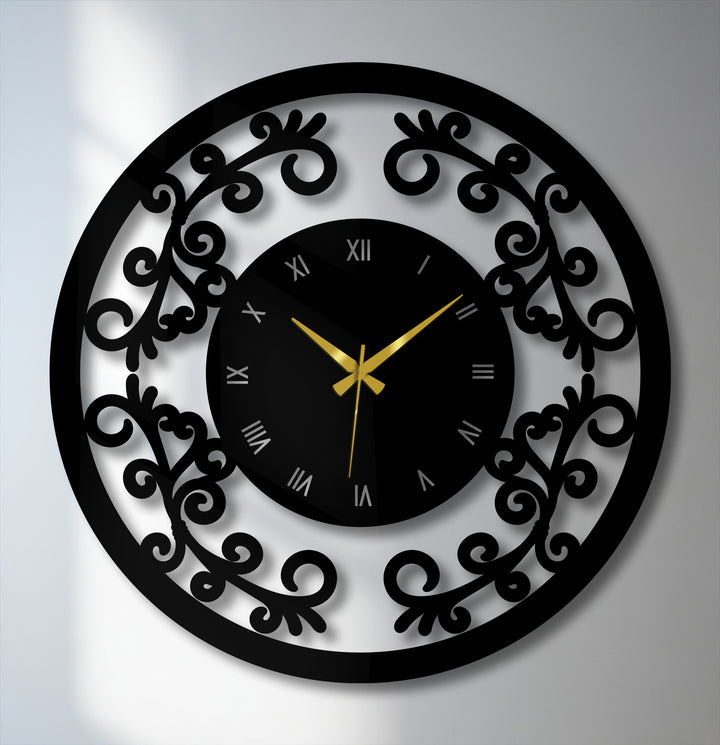 The color shift from black numerals to gold hands highlights the ornamental floral frame on this vintage metal wall decor clock.
