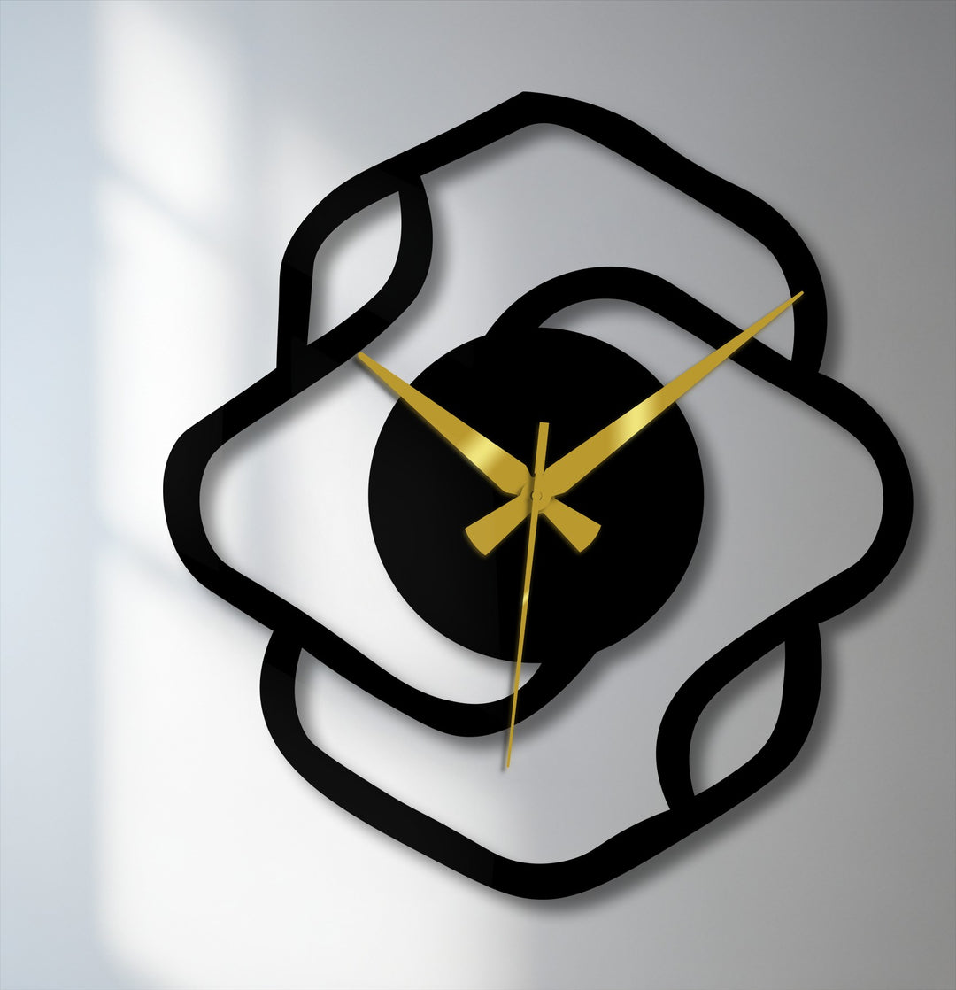 Examining the realistic detail, this abstract organic shape modern metal wall clock features black decoration wall art and striking gold hands.