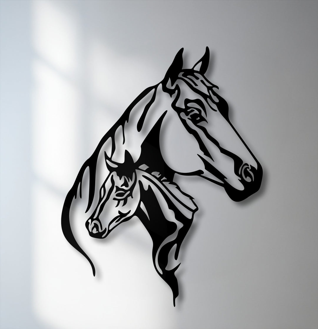 The darkest area highlights the sleek, stylized black silhouettes of a mare and her foal, forming a unique metal wall art piece.