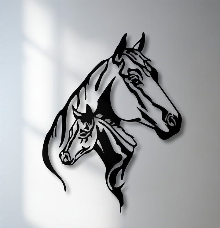The darkest area highlights the sleek, stylized black silhouettes of a mare and her foal, forming a unique metal wall art piece.