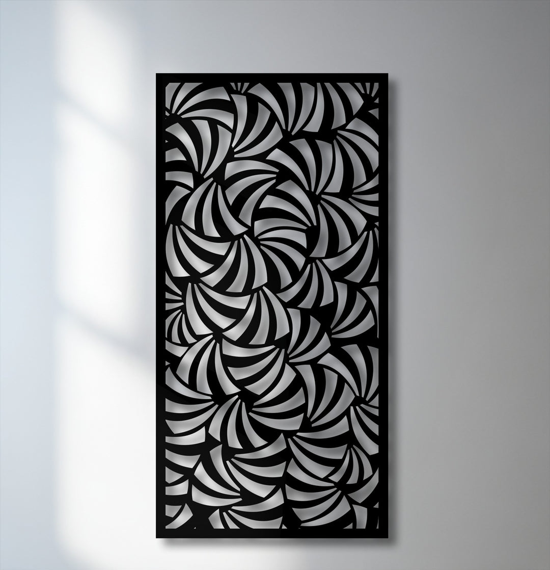 Interplay of dramatic light and shadow highlights the intricate spiral design of this modern geometric metal artwork panel.