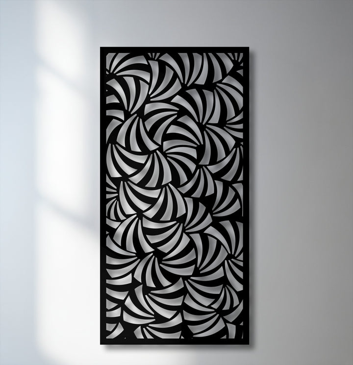 Interplay of dramatic light and shadow highlights the intricate spiral design of this modern geometric metal artwork panel.