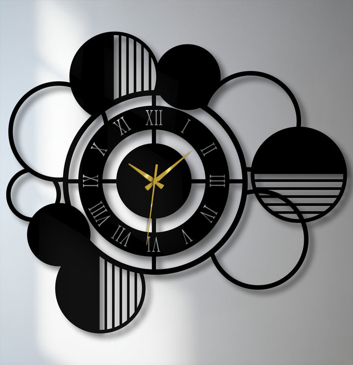 Geometric metal artwork defines this modern wall clock, composed of intersecting circles, bold Roman numerals, and minimalist lines for stylish home decor.