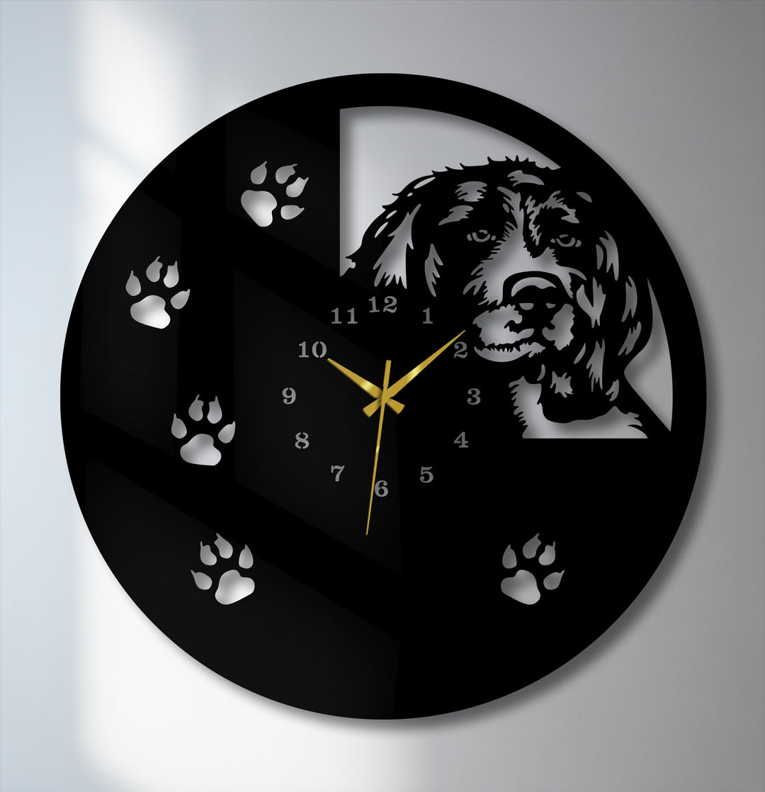 The sleek matte black finish of this metal wall decor showcases a glossy silver dog silhouette, paw prints, and numbers.