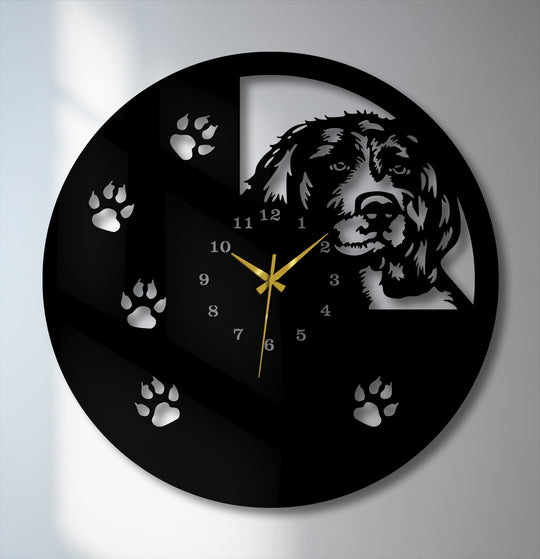 The sleek matte black finish of this metal wall decor showcases a glossy silver dog silhouette, paw prints, and numbers.