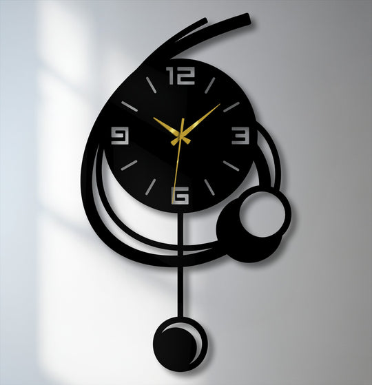 Striking color contrast defines this modern orbit metal artwork wall clock, featuring minimalist geometric shapes and gold hands against a dark background.