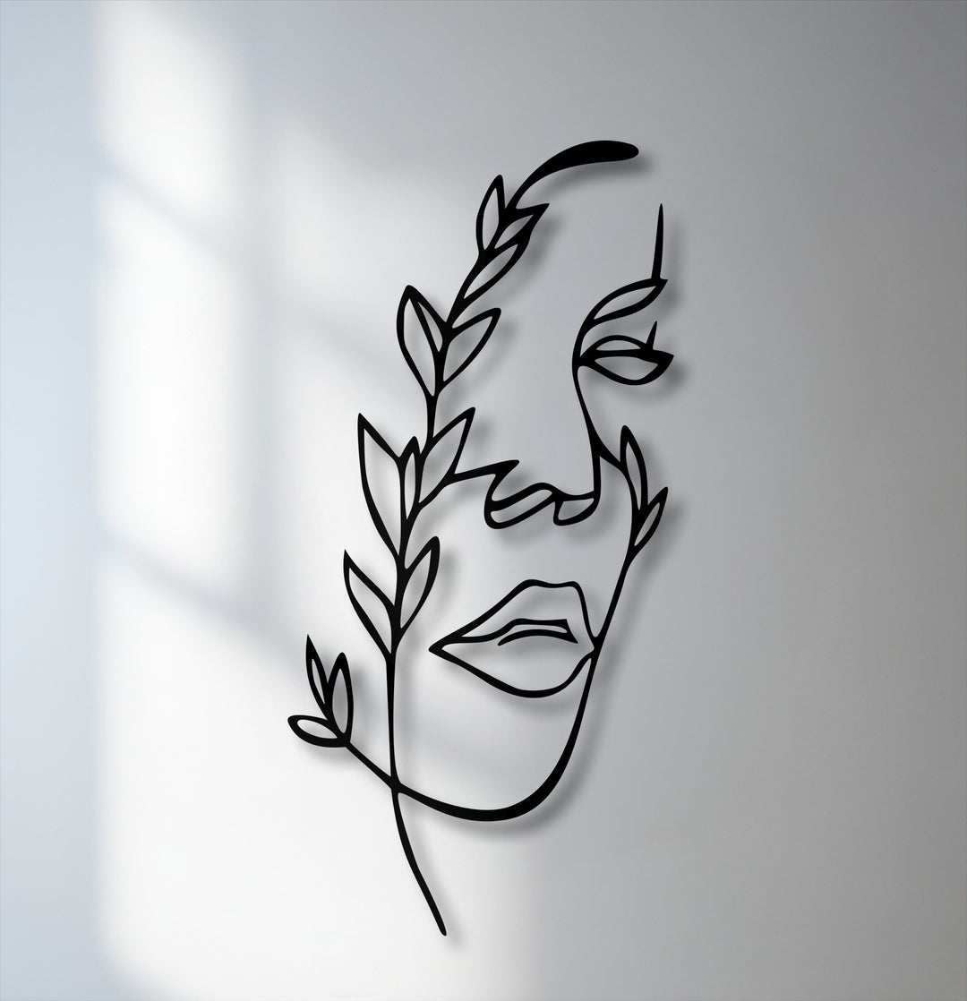 Geometric abstract lines form a unique metal wall art featuring a minimalist female face intertwined with flowing botanical elements.