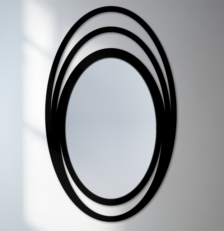 Quality framed wall mirror construction highlights the glossy black finish of the Triple Halo Oval Wall Mirror's layered metal rings.