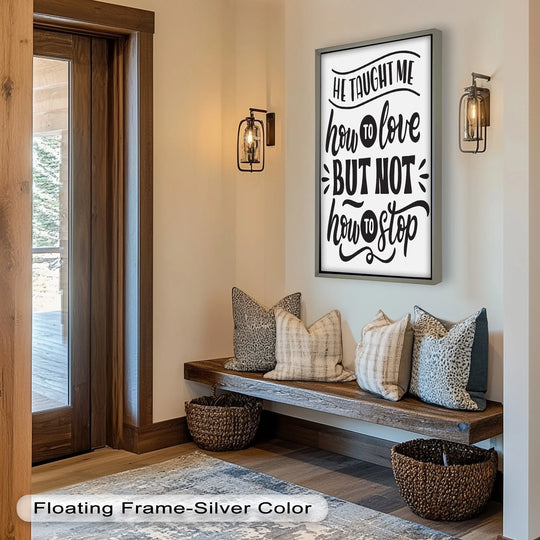 Displayed is the central subject, a framed oil painting artwork stating, 'He taught me how to love but not how to stop,' hung above a rustic entryway bench.