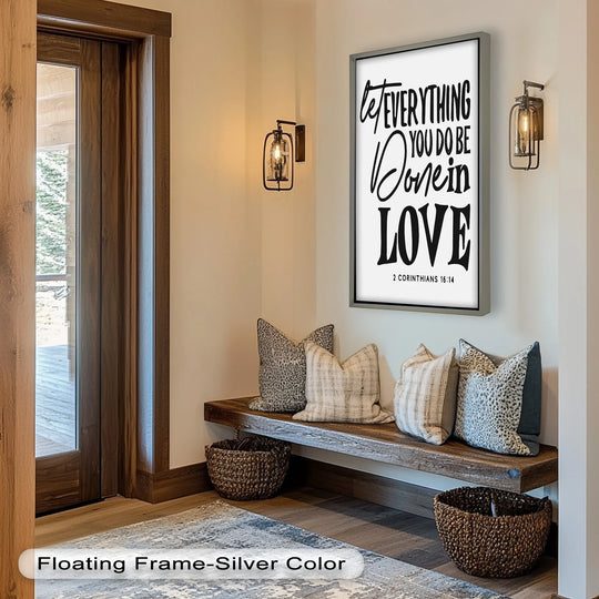 Silver finish frames a scripture oil painting decoration, 'Let Everything Be Done in Love,' displayed above a rustic bench with woven baskets.