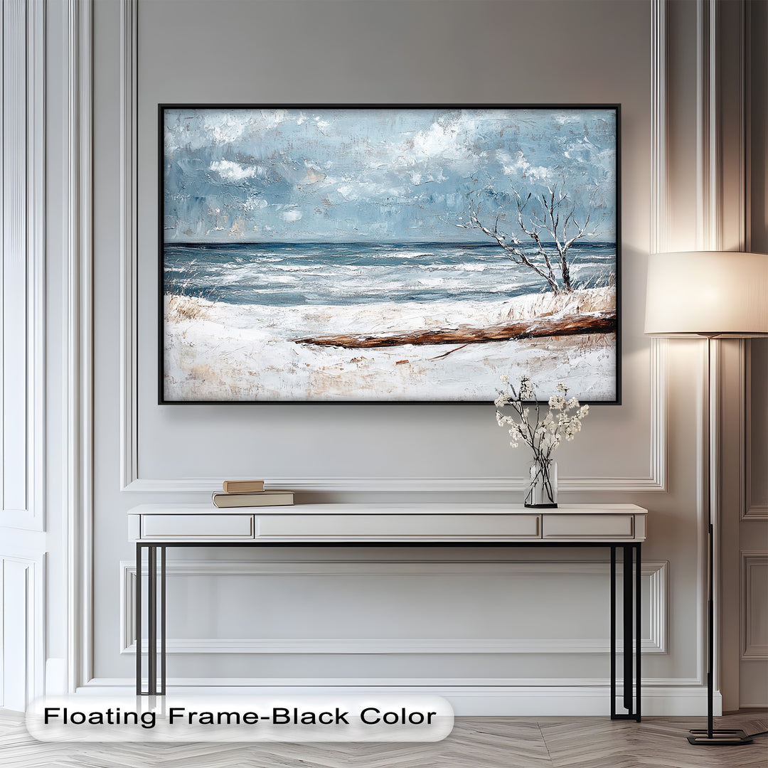 This winter seascape painting captures the quiet beauty of a snow-covered shoreline with a bare tree and icy waves beneath a soft, cloudy sky.