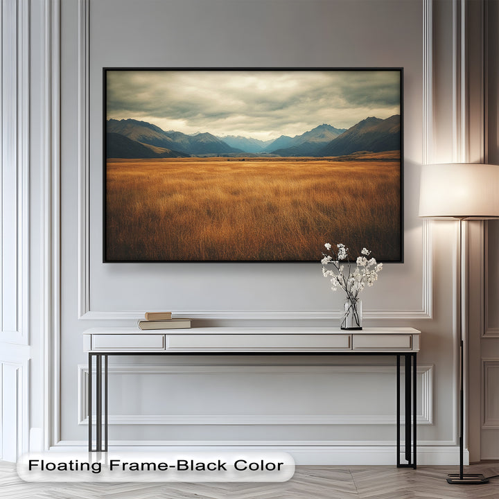 Nature-inspired artwork of rolling hills and distant blue mountains.
