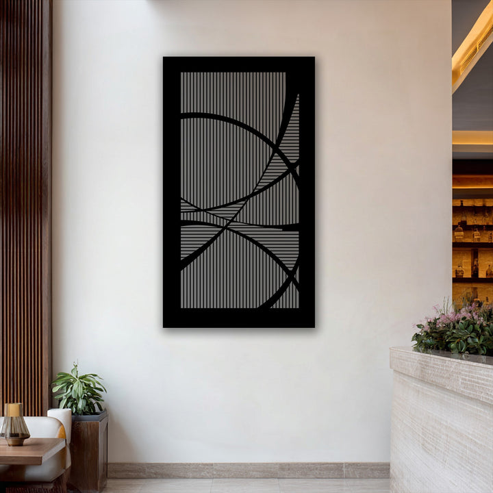 Light and shadow dramatically emphasize the geometric lines and curves of this modern abstract decorative metal art.
