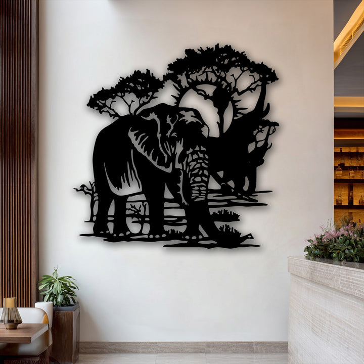 Creamy white wall displays striking black silhouette elephant landscape metal artwork under two trees.