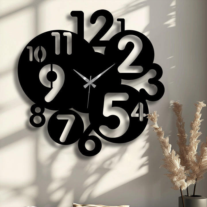 The striking transition from deep black of this metal art for wall to the bright wall visible through the abstract numbers defines this modern clock.